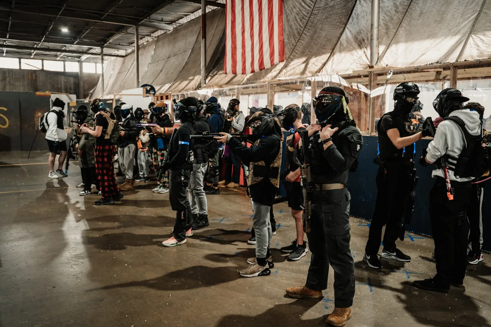 Masked players lined up at the safe line under the American flag