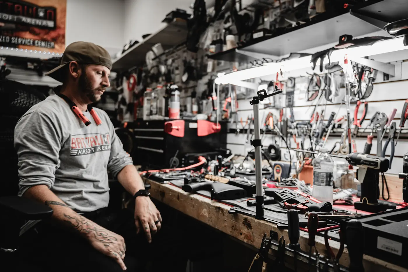 The in-house tech at his workbench in front of a wall of tools